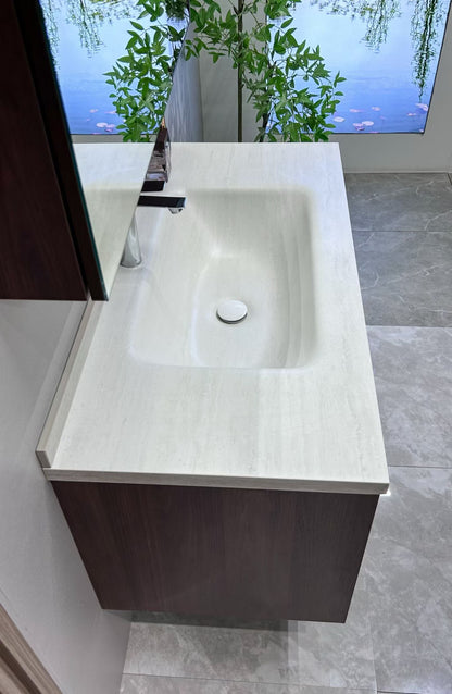 A luxurious solid wood bathroom cabinet with a walnut finish, a washbasin, and an integrated stone slab – an eco-friendly bathroom cabinet.