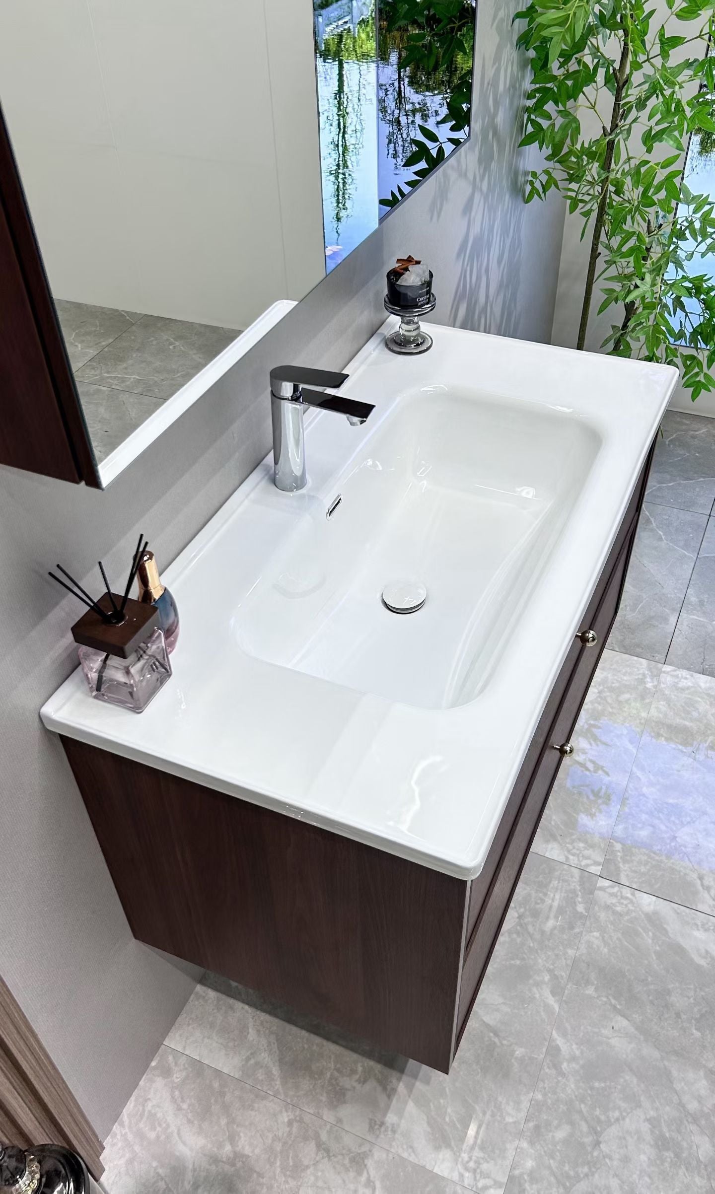 A luxurious solid wood bathroom cabinet with a walnut finish, a washbasin, and an integrated stone slab – an eco-friendly bathroom cabinet.