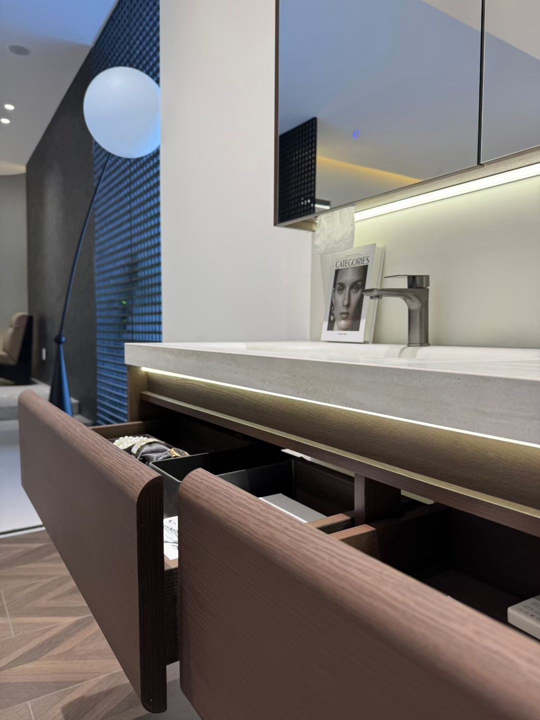 Custom-made cabinet made of red oak, hotel-style custom bathroom vanity, wash basin, and integrated stone slab with seamless design.