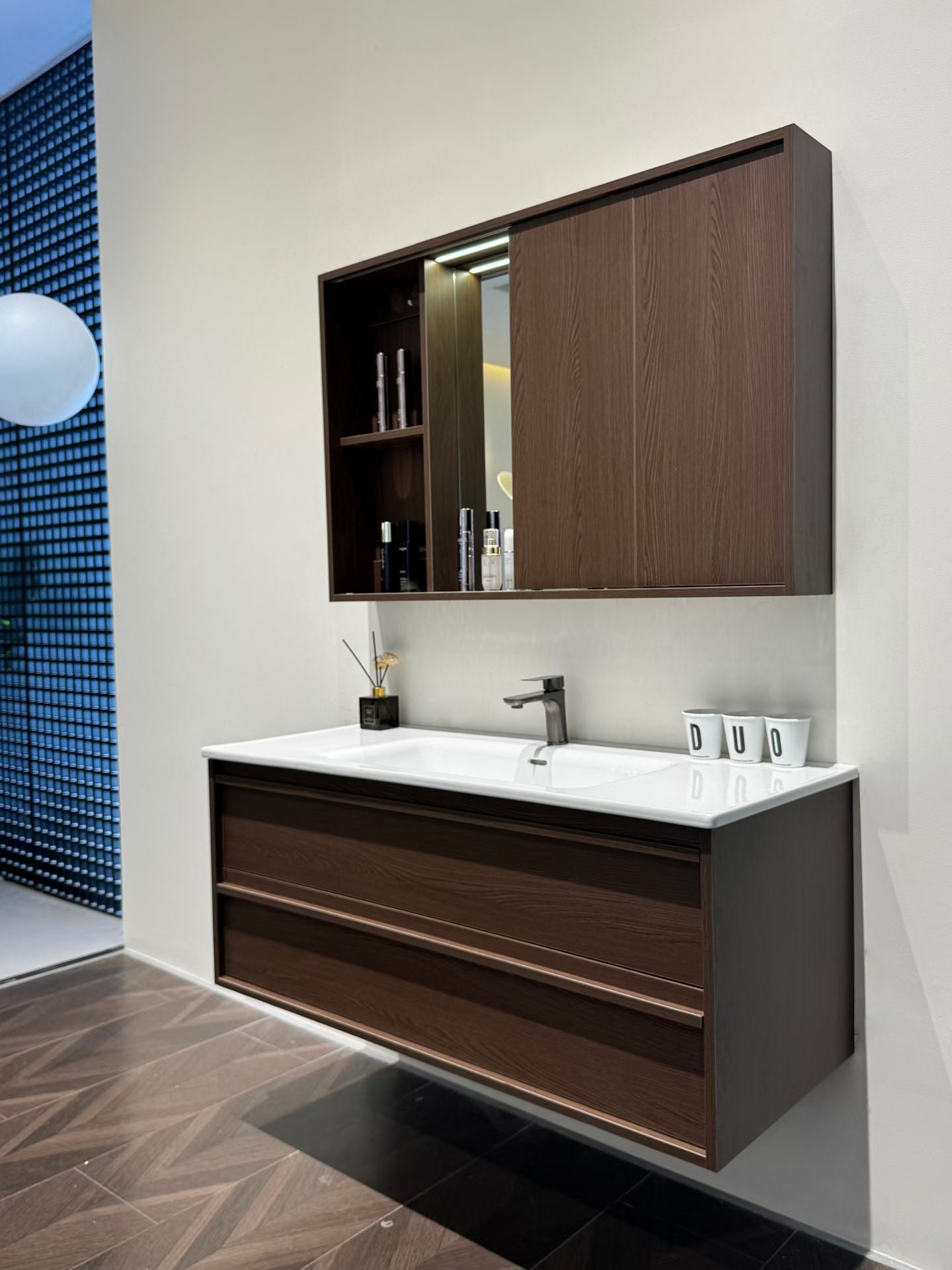 A luxurious solid wood bathroom cabinet with a walnut finish, a washbasin, and an integrated stone slab – an eco-friendly bathroom cabinet