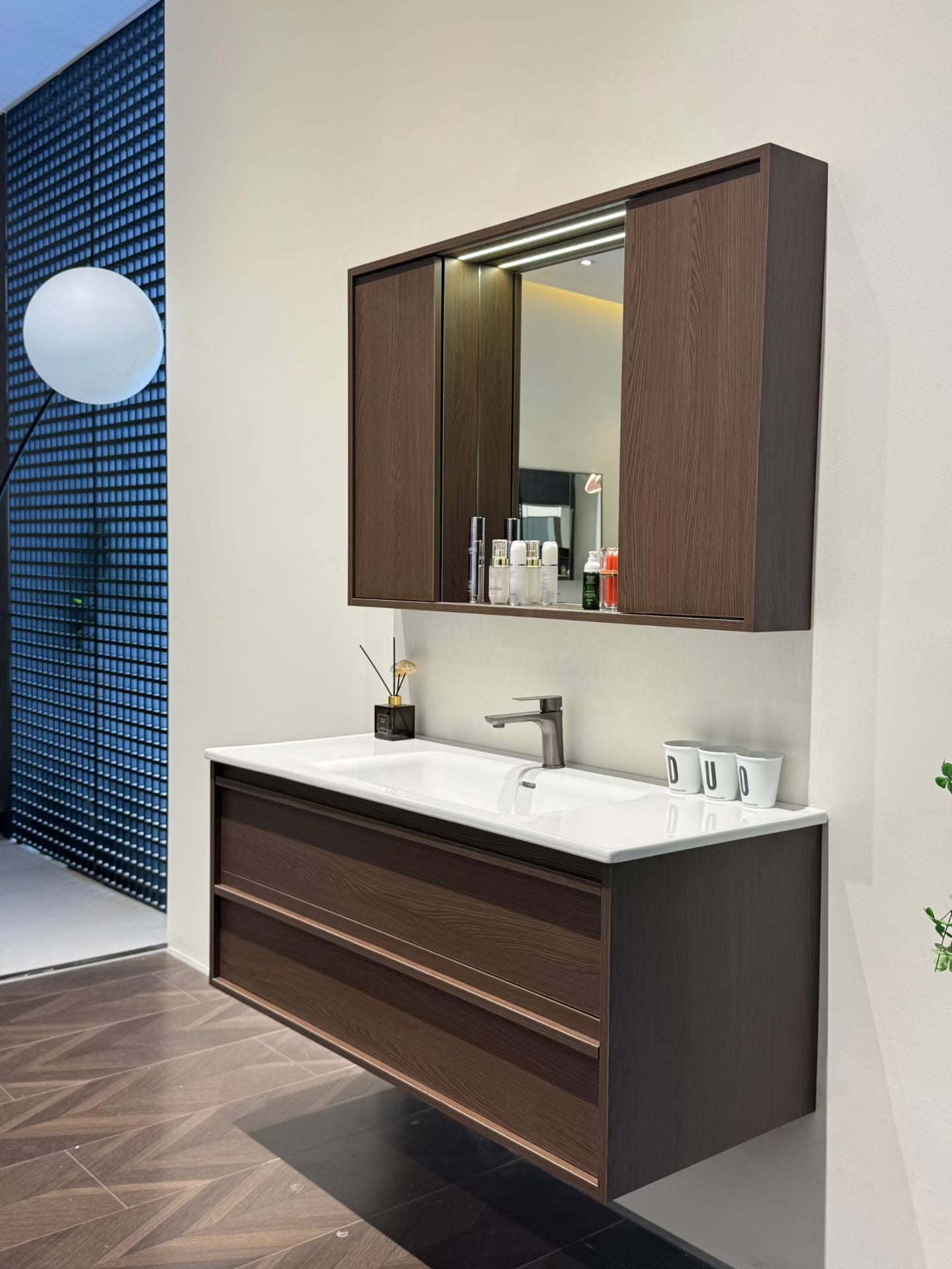 A luxurious solid wood bathroom cabinet with a walnut finish, a washbasin, and an integrated stone slab – an eco-friendly bathroom cabinet