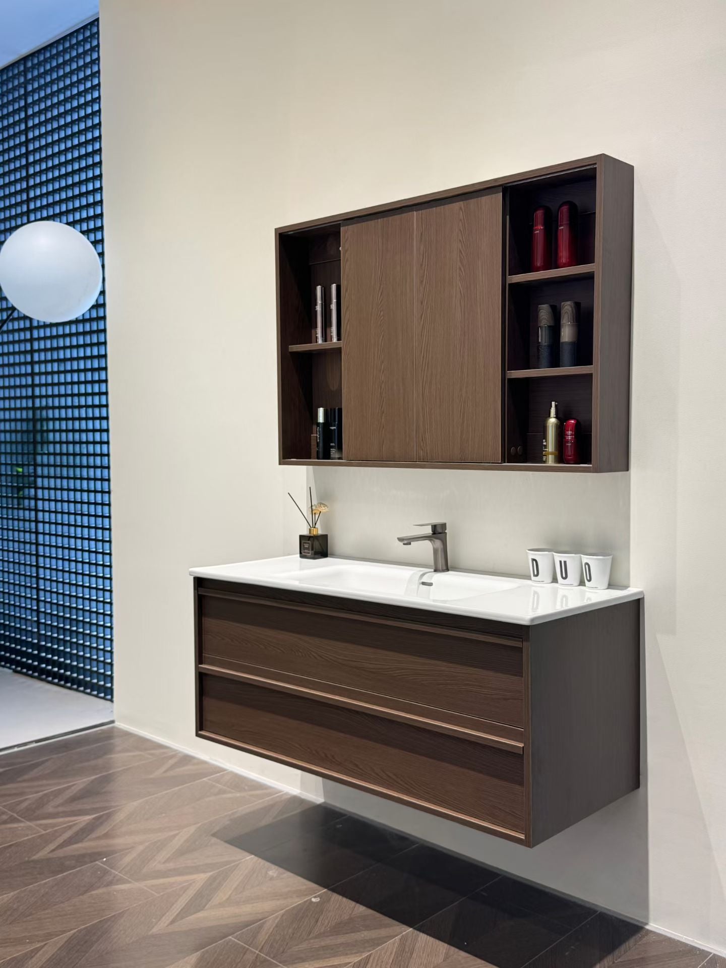 A luxurious solid wood bathroom cabinet with a walnut finish, a washbasin, and an integrated stone slab – an eco-friendly bathroom cabinet