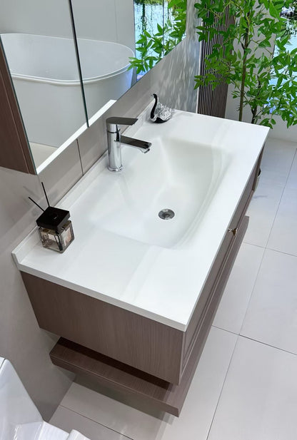 Custom-made cabinet made of red oak, hotel-style custom bathroom vanity, wash basin, and integrated stone slab with seamless design