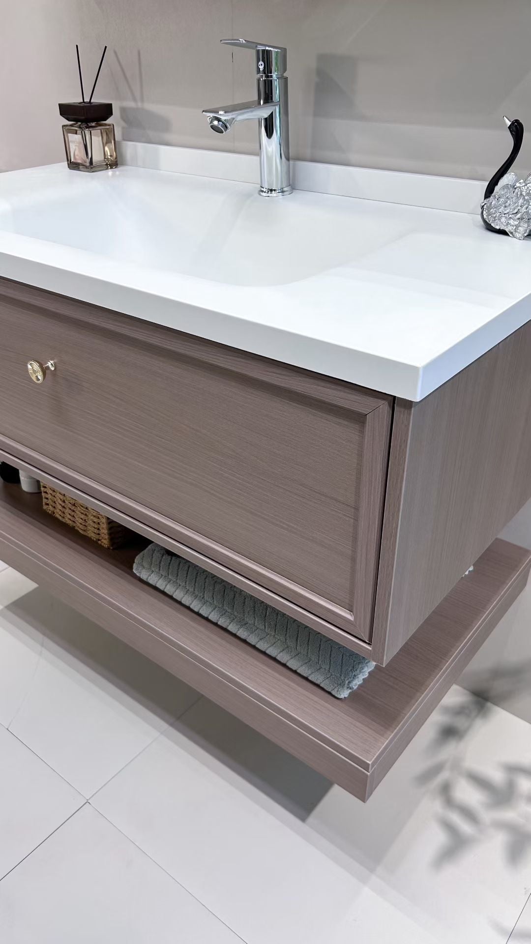 Custom-made cabinet made of red oak, hotel-style custom bathroom vanity, wash basin, and integrated stone slab with seamless design